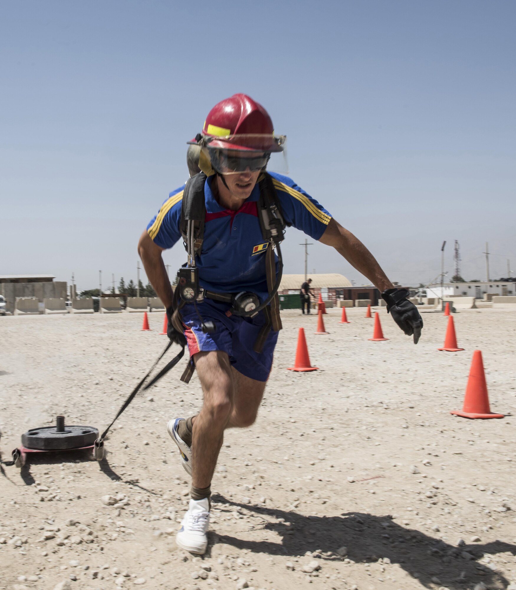 Romanian Pfc. Florin Dragnuta, 265th Military Police Detachment, completes a sled pull during the battle of the Badges competition, Bagram Airfield, Afghanistan, Aug. 7, 2016. Participants competed to prove who is the best in activities that included a tire lift, sled pull, weapons assembly, dummy carry, shoot-out, tug-of-war and moving a HUMVEE. (U.S. Air Force photo by Tech. Sgt. Tyrona Lawson)
