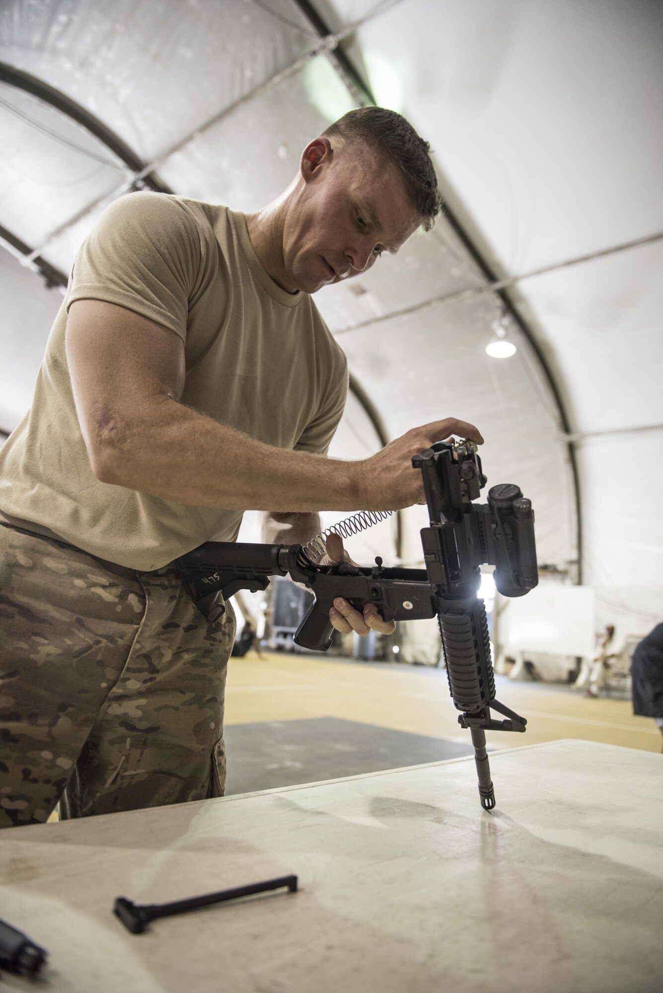 U.S. Air Force Capt. Shawn Chamberlin, 455th Expeditionary Security Forces commander, reassembles an M4 carbine while competing in a Battle of the Badges competition, Bagram Airfield, Afghanistan, Aug. 7, 2016. The 4 member teams competed in a relay of disassembling and reassembling the weapon for the best time. (U.S. Air Force photo by Tech. Sgt. Tyrona Lawson)