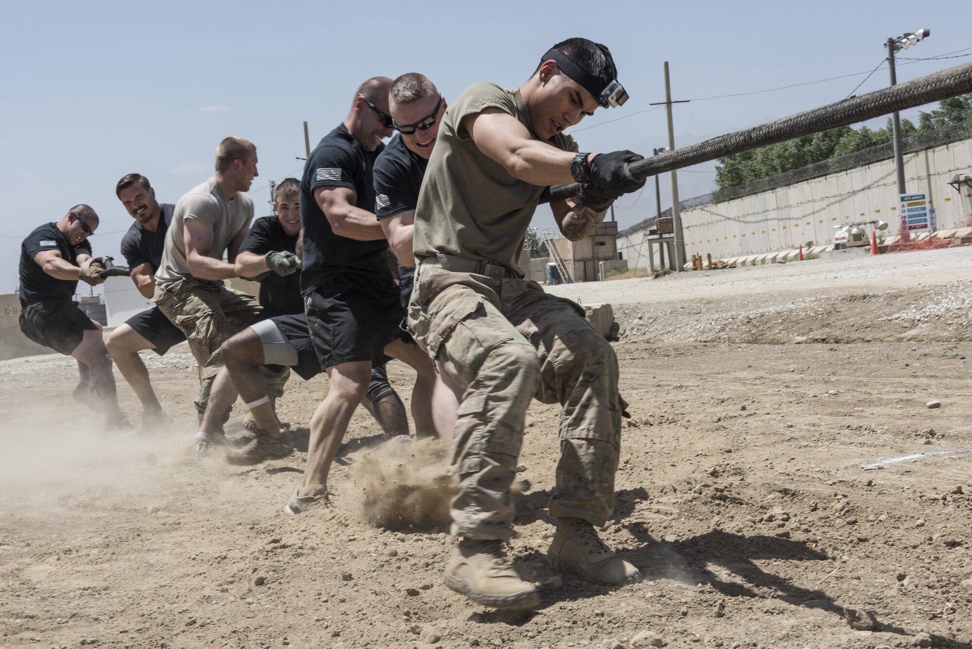 Members of the 822nd Military Police Detachment and the 137th Military Detachment pull on a rope during a tug-of-war competition, Bagram Airfield, Afghanistan, Aug. 7, 2016. In an all or nothing battle between Air Force and Army members, participants relied on their strength, endurance and team work to overcome one another. (U.S. Air Force photo by Tech. Sgt. Tyrona Lawson)
