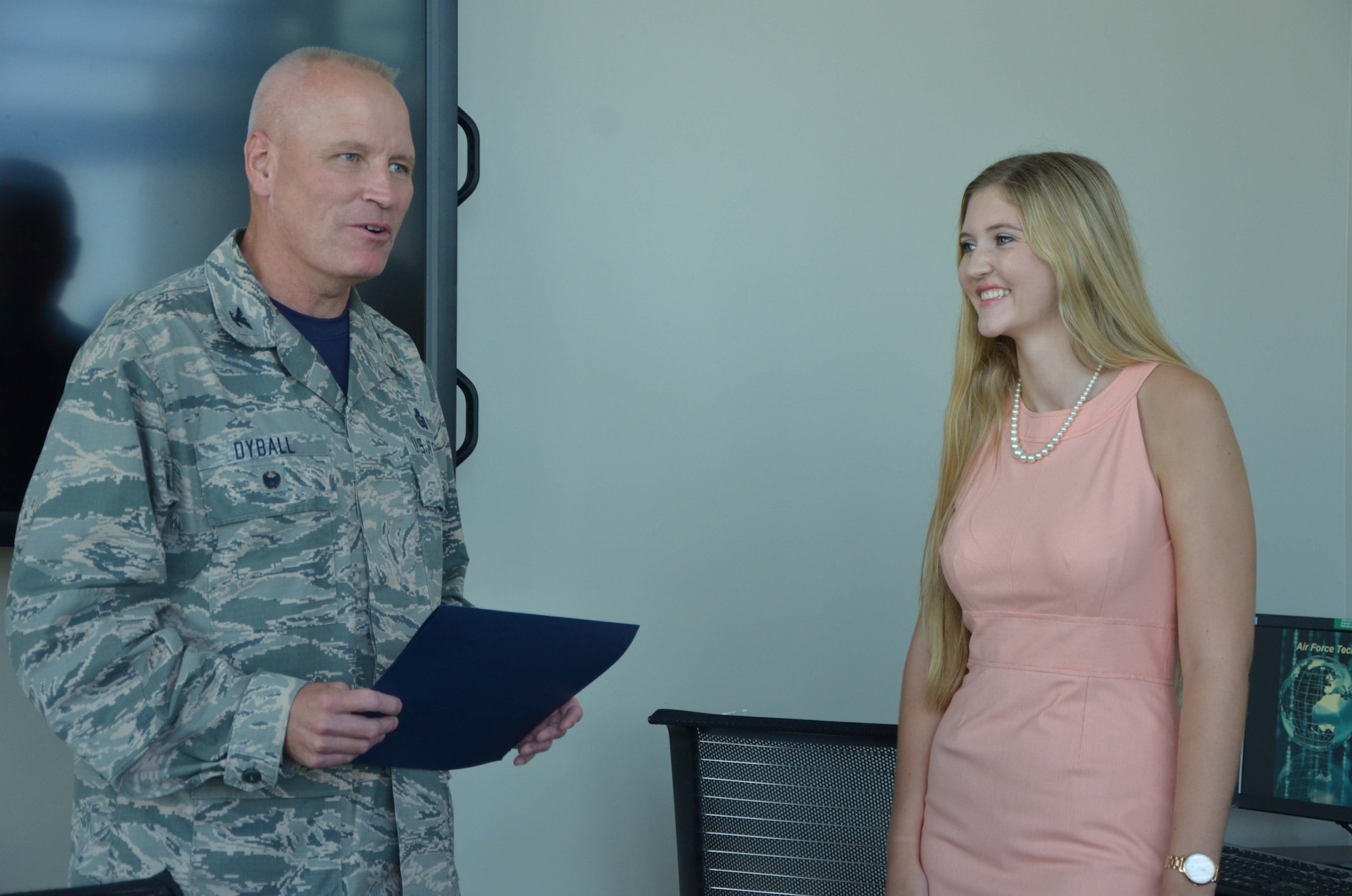 Col. Jeffrey W. Dyball, vice commander of the Air Force Technical Applications Center, Patrick AFB, Fla., presents a certification of recognition to Madison Zook, recipient of AFTAC Company Grade Officer Council’s annual scholarship.  Zook, a recent Edgewood Jr./Sr. High School graduate, received the $500 award July 29, 2016 for her essay on business analytics.  (U.S. Air Force photo by Susan A. Romano)