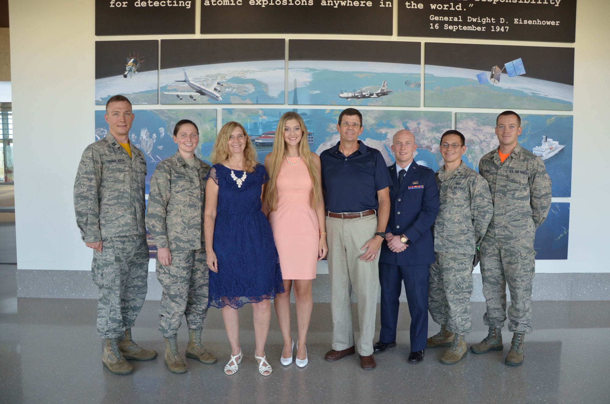 Madison Zook (center), poses with her parents Rhonda and Lee July 29, 2016 after members of the Air Force Technical Applications Center’s Company Grade Officers Council presented the teen with the council’s annual $500 cholarship award in AFTAC’s headquarters located at Patrick AFB, Fla.  From left to right: Capt. Stefan Fagan-Kelly, 2nd Lt. Emily Theobald, Rhonda Zook, Madison Zook, Lee Zook, 1st Lt. Michael Duff, 1st Lt. Joshua Hall and 2nd Lt. James Stofel. (U.S. Air Force photo by Susan A. Romano)