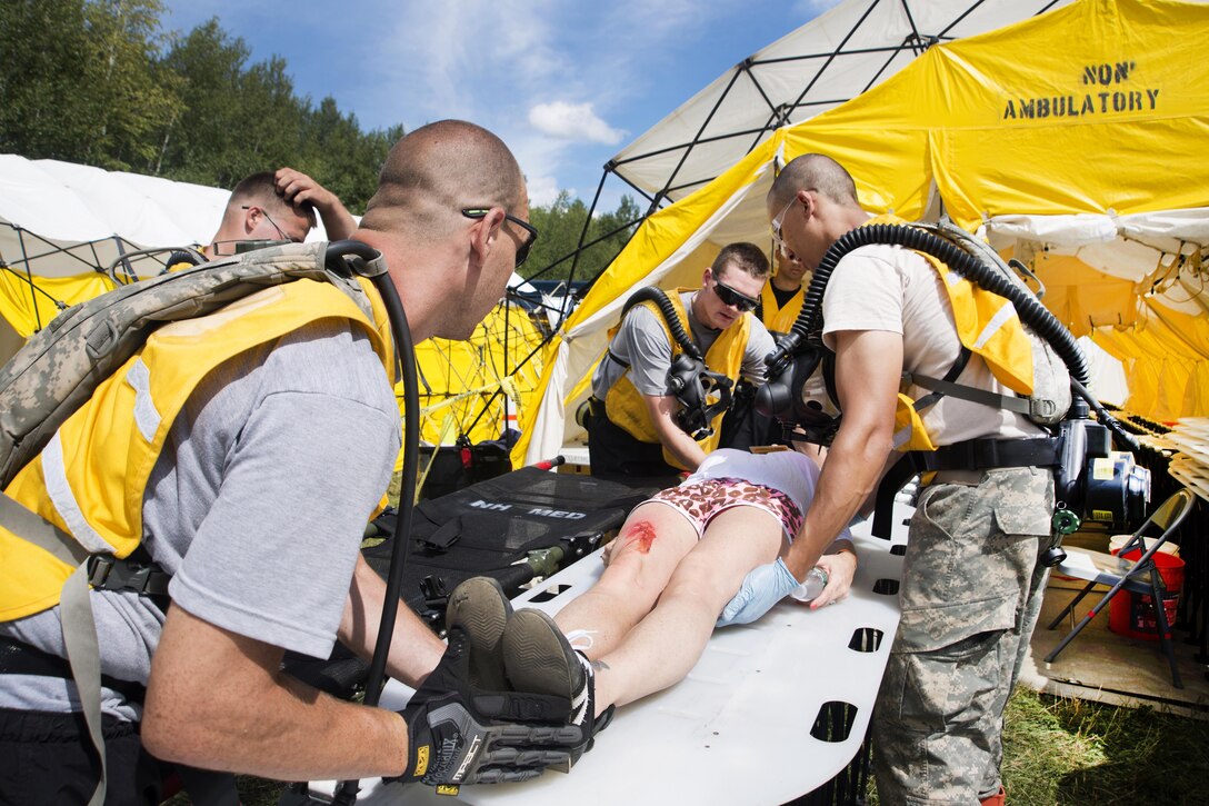 Soldiers push a role-playing patient on the decontamination line during Vigilant Guard 2016 at Camp Johnson, Colchester, Vt., July 30, 2016. Air National Guard photo by Airman 1st Class Jeffrey Tatro