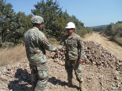 Sgt. James Lewis, a communications specialist with the 766th Engineer Company (Horizontal), 841st Engineer Battalion, U.S. Army Reserve, is presented a command team coin for excellence by Maj. Chrustowski, Headquarters and Headquarters Company, 841st Engineer Battalion. Although he normally services and maintains communications equipment Lewis led the way and was instrumental in driving a dump truck, allowing increased productivity by the unit. (U.S. Army photo by Capt. Jose F. Lopez Jr., 841st Eng. Bn., United States Army Reserve)