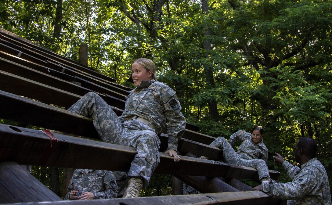 Task Force Wolf instructor, Army Reserve Sgt. 1st Class Frank Beman, from the 2nd of the 399th Training Support Battalion (ROTC) coaches Cadet Initial Entry Training (CIET) candidates through The Weaver obstacle  during U.S. Army ROTC Cadet Summer Training (CST16), at Ft Knox, Ky., June 6. (U.S. Army Reserve photo by Sgt. Karen Sampson/ Released).