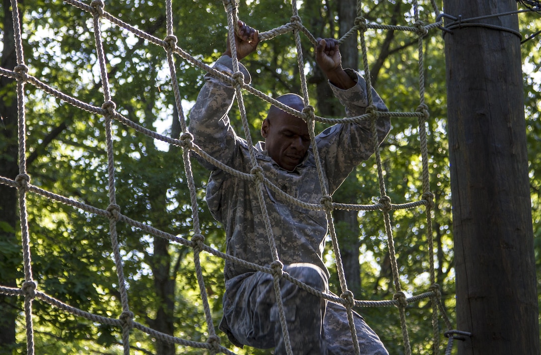 Task Force Wolf instructor, Army Reserve Sgt. 1st Class Harry Bowles from the 2nd of the 399th Training Support Battalion (ROTC), demonstrates the correct way to master The Tough One for the Cadet Initial Entry Training (CIET) candidates on the confidence course during U.S. Army ROTC Cadet Summer Training (CST16), at Ft Knox, Ky., June 8. (U.S. Army Reserve photo by Sgt. Karen Sampson/ Released).