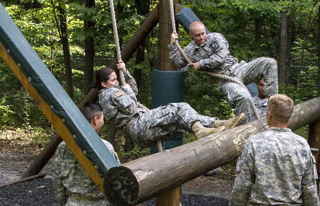 An Army Reserve instructor from Task Force Wolf grades Cadet Initial Entry Training (CIET) candidates performing the Swing, Stop and Jump obstacle on the confidence course at U.S. Army Cadet Command during Cadet Summer Training (CST16), Ft. Knox, Kentucky, June 18. (U.S. Army Reserve photo by Sgt. Karen Sampson/ Released)