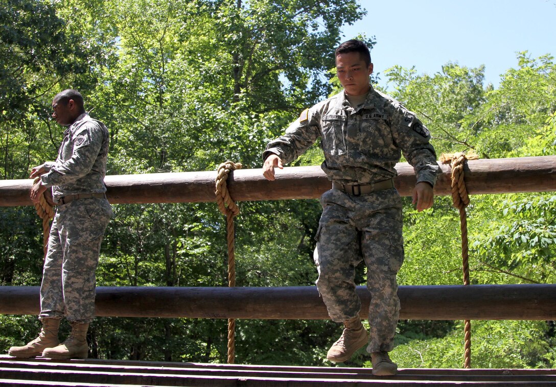 Task Force Wolf instructor from the 2nd of the 399th Training Support Battalion (ROTC) coaches a Cadet Initial Entry Training (CIET) candidate through The Tough One obstacle  during U.S. Army ROTC Cadet Summer Training (CST16), at Ft Knox, Ky., June 8. (U.S. Army Reserve photo by Sgt. Karen Sampson/ Released).