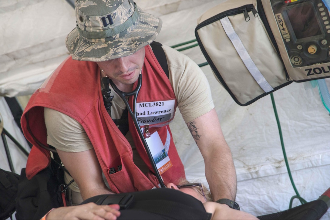 Airmen treat a role-playing patient during Vigilant Guard 2016 at Camp Johnson, Colchester, Vt., July 30, 2016. Air National Guard photo by Airman 1st Class Jeffrey Tatro