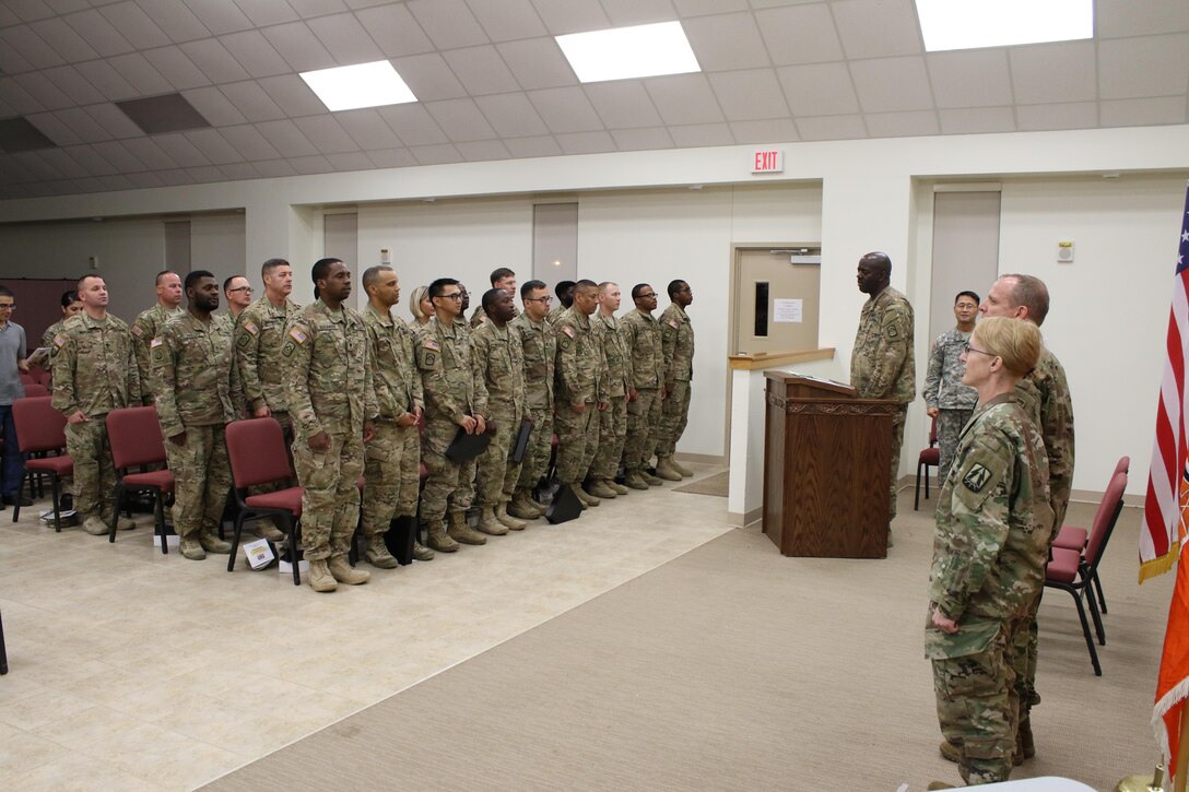 Army Reserve Soldiers from Detachment 11, 335th Signal Command (Theater) stand up in preparation to sing the Army Song during a Welcome Home Warrior Ceremony at North Fort Hood, Texas Aug. 3.  The detachment of 24 Soldiers spent the last nine months deployed to Afghanistan in support of Operation Enduring Freedom and the ongoing war on terrorism.   Their mission comprised of providing, maintaining, repairing and establishing electronic communications throughout the Afghan theater of operations.