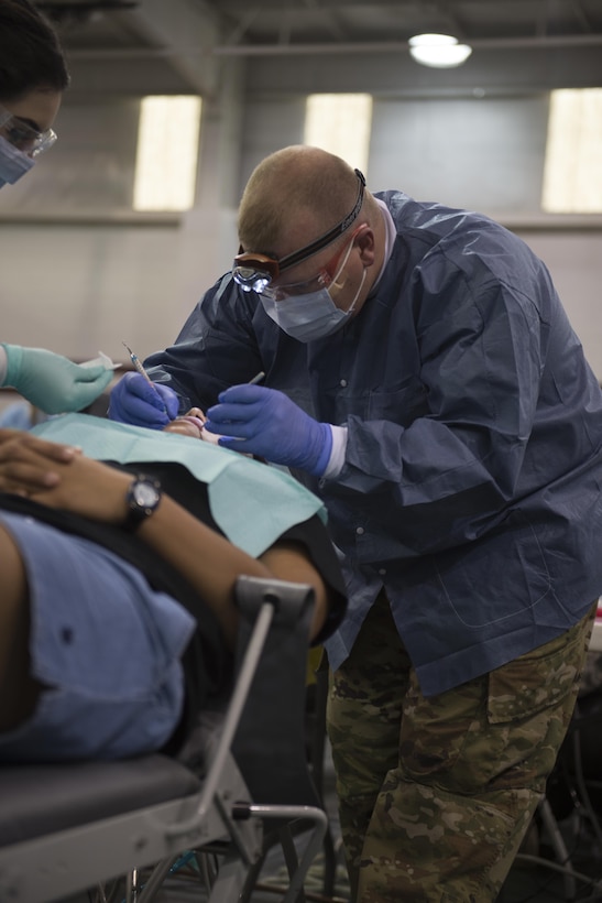 A U.S. Army Reserve Soldier provides dental services to a Texas resident at an Operation Lone Star medical point in Pharr, Texas, July 27, 2016. Service members from the Texas State Guard worked alongside Soldiers from the 804th Medical Brigade, U.S. Army Reserve, the Texas Department of Public Safety, the Department of State Health Services, Remote Area Medical volunteers, Cameron County Department of Health and Human Services (DHHS), City of Laredo Health Department, Hidalgo County DHHS and U.S. Public Health Services during Operation Lone Star (OLS), a week long real-time, large-scale emergency preparedness exercise in La Joya, Pharr, Brownsville, Rio Grande City and Laredo, Texas, July 25-29, 2016. OLS is an annual medical disaster preparedness training exercise, uniting federal, state and local health and human service providers, that addresses the medical needs of thousands of underserved Texas residents every year. (U.S. Army National Guard photo by Sgt. 1st Class Malcolm McClendon)