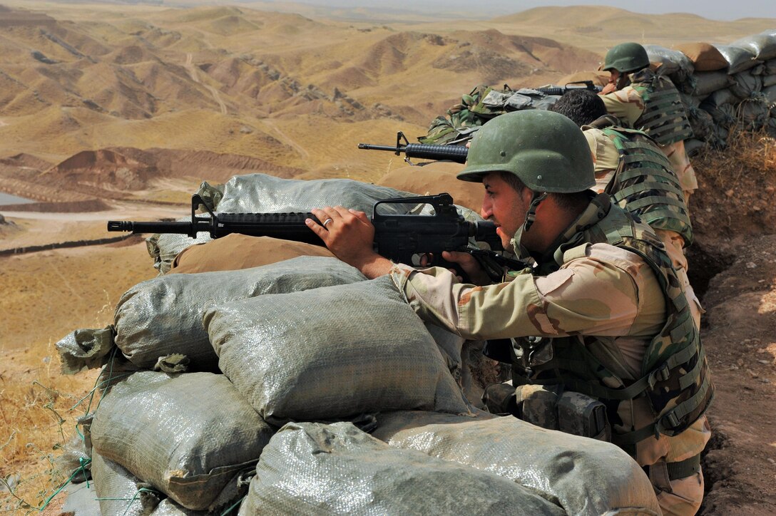 Peshmerga soldiers prepare for an attack along the simulated front lines during training at the Menila Training Center in northern Iraq, July 26. DLA Troop Support Subsistence provided food to Peshmerga forces to support their efforts in the fight against ISIL.