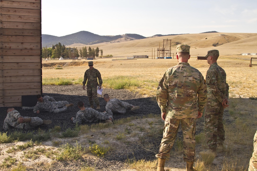 U.S. Army Reserve Command, Command Sergeant Major (Interim), Command Sgt. Maj. James P. Wills watches on as the USARC Best Warrior winners and runner-ups from the 2016 BWC competition stretch after an obstacle course training at Fort Harrison, MT, August 5, 2016. The USARC BWC winners from the noncommissioned officer and Soldier category are going through rigorous training, leading up to their appearance at Fort A.P. Hill later this year for the Department of Army BWC. (U.S. Army Reserve photo by  Brian Godette, USARC Public Affairs)