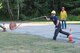 Capt. Joe Segien, New Boston Fire Department firefighter, throws a hose during the NBFD’s “First Helmet” competition at New Boston Air Force Station, New Hampshire, Wednesday, July 27, 2016. Seigen and other firefighters participated in the competition that tested the speed and efficiency of each department member. (Courtesy photo)