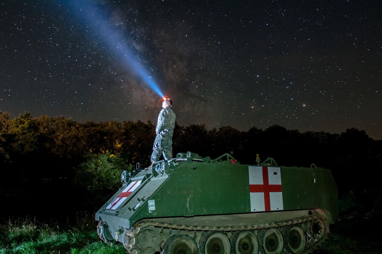 Army Staff Sgt. Brad Foster, a combat medic with the Oregon Army National Guard’s Headquarters and Headquarters Company, 3rd Battalion, 116th Heavy Brigade Combat Team from Pendleton, Ore., looks up at the night sky from the top of an M113 medical evacuation vehicle during Exercise Saber Guardian 16 at the Romanian Land Forces Combat Training Center in Cincu, Romania, Aug. 3, 2016. Army photo by Spc. Timothy Jackson