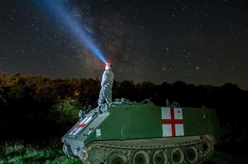 Army Staff Sgt. Brad Foster, a combat medic with the Oregon Army National Guard’s Headquarters and Headquarters Company, 3rd Battalion, 116th Heavy Brigade Combat Team from Pendleton, Ore., looks up at the night sky from the top of an M113 medical evacuation vehicle during Exercise Saber Guardian 16 at the Romanian Land Forces Combat Training Center in Cincu, Romania, Aug. 3, 2016. Army photo by Spc. Timothy Jackson