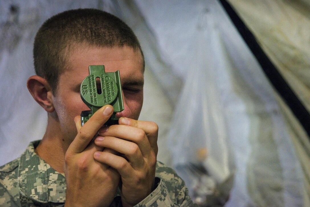 A soldier participates with a lensatic compass during land navigation training during Vigilant Guard 2016 at Camp Ethan Allen Training Site, Jericho, Vt., July 28, 2016. The soldier is assigned to the Vermont National Guard’s Headquarters Company, 86th Infantry Brigade Combat Team (Mountain). Air National Guard photo by Airman 1st Class Jeffrey Tatro 