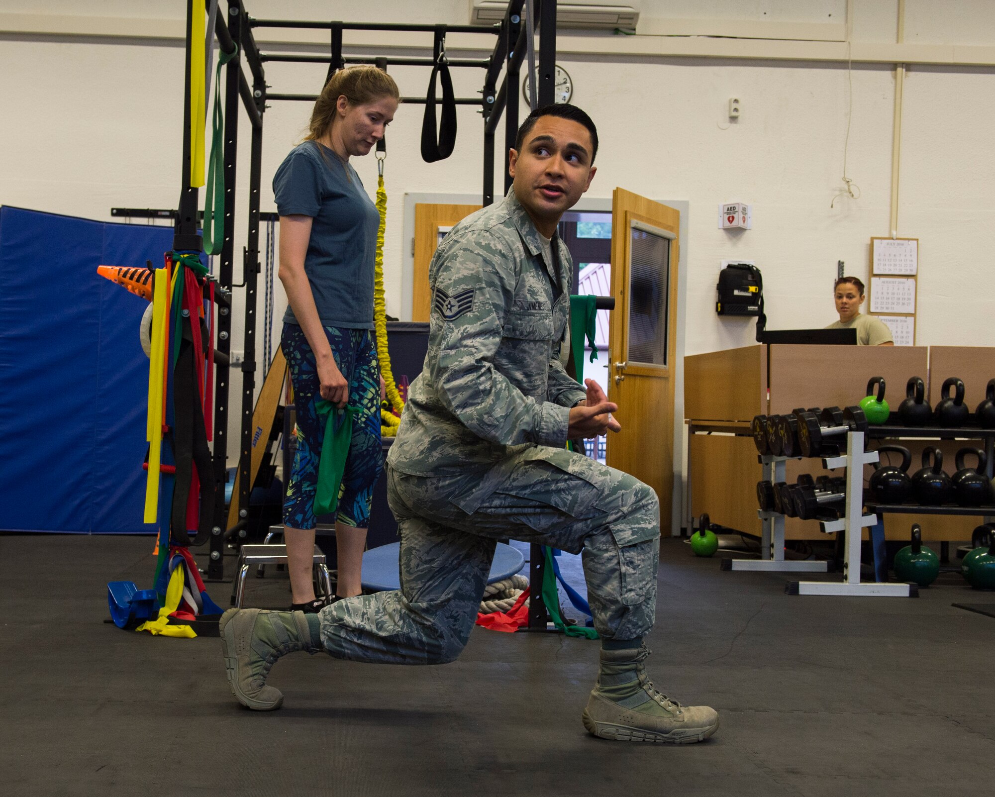 Staff Sgt. Mario Jimenez, 86th Medical Operations Squadron physical therapy technician, demonstrates proper lunge form during a knee rehabilitation class at Ramstein Air Base, Germany, Aug. 2, 2016. Due to manning, the knee and back rehabilitation classes were created to provide instruction to numerous patients with similar injuries and exercise routines. (U.S. Air Force photo/ Senior Airman Nesha Humes)