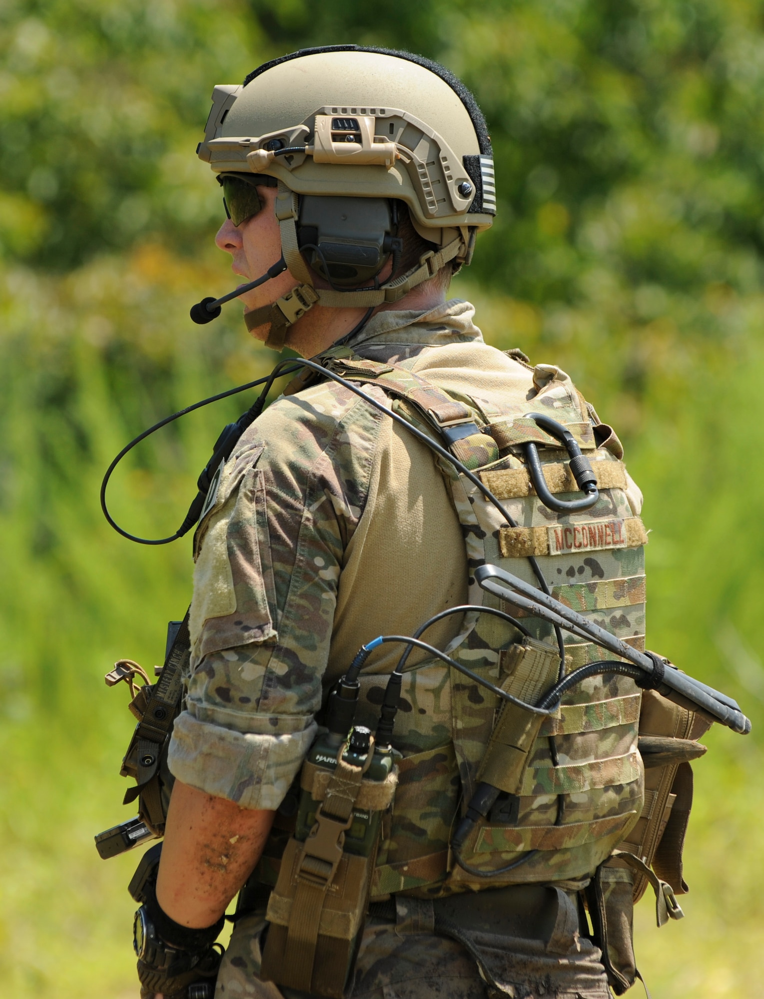 U.S. Air Force Airman 1st Class Tyler McConnell, an explosive ordnance disposal (EOD) team member assigned to the 509th Civil Engineer Squadron, radios in for updates during the Operation Thunder Weasel exercise  at the Truman Lake National Guard Training Site, Mo., July 27, 2016.  The EOD members utilized their attached support element to confirm the location of a weapons cache. (U.S. Air Force photo by Senior Airman Danielle Quilla)