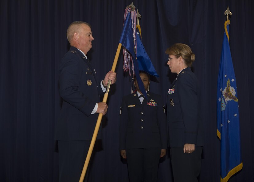 Lt. Col. Jennifer Aquinas, outgoing 512th Security Forces Squadron commander, exchanges the guidon with Col. Scott Durham, 512th Airlift Wing commander, during the 512th SFS change of command ceremony Aug. 6, 2016.  Aquinas relinquished her command to incoming commander, Maj. Alexander Logan. (U.S. Air Force Photo/ Tech. Sgt. Nathan Rivard)