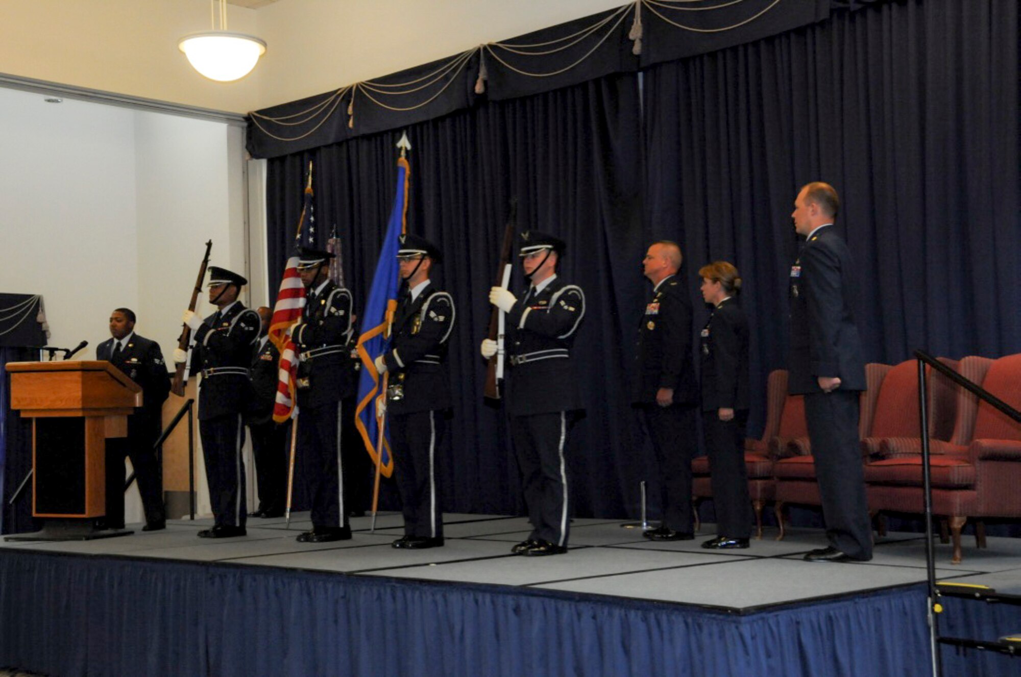 Members of the 512th Air Wing stand at attention as the National Anthem is sung at a 512th Security Forces Squadron change of command Aug. 6, 2016 at Dover Air Force Base, Del. Lt. Col. Jennifer Aquinas relinquished command to Major Alexander Logan at the ceremony. (U.S. Air Force Photo/ Sgt. Tiffany Lindemann) 