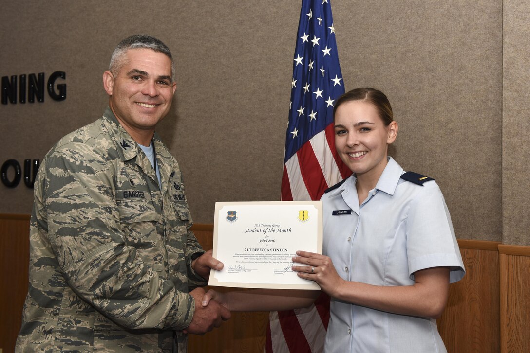 U.S. Air Force Col. Alejandro Ganster, 17th Training Group Commander, presents the 315th Training Squadron Officer Student of the Month award for July 2016 to 2nd Lt. Rebecca Stinton at Brandenburg Hall on Goodfellow Air Force Base, Texas, Aug. 5, 2016. (U.S. Air Force photo by Airman 1st Class Chase Sousa/Released)