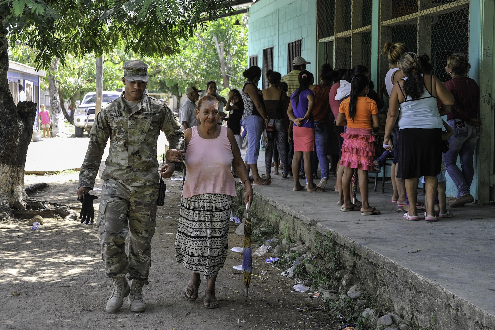 U.S. Army Pvt. Gabriel Hassoun, Joint Task Force-Bravo Army Forces, walks with an elderly woman during a Medical Readiness Training Exercise operation in Trujillo, Honduras, July 29, 2016. While MEDRETEs greatly help the local populations where they are conducted, the service members executing the operations also receive valuable medical training and experience that comes from operating in remote and/or austere environments. (U.S. Air Force photo by Staff Sgt. Siuta B. Ika)
