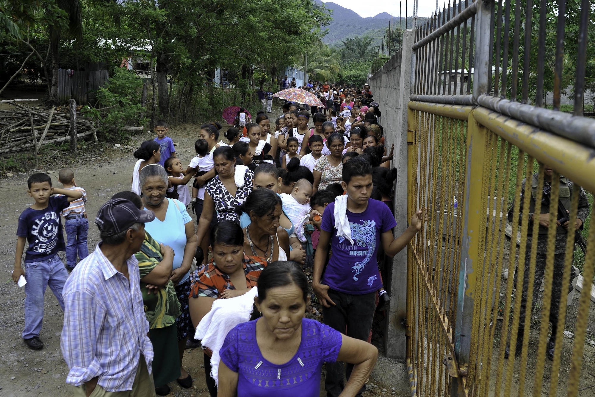 Locals wait outside the compound where the Joint Task Force-Bravo Medical Element hosted a Medical Readiness Training Exercise operation in Trujillo, Honduras, July 29, 2016. The villages where the MEDRETEs take place provide space at the schools, churches or community centers to see patients, and community leaders help with event promotion. (U.S. Air Force photo by Staff Sgt. Siuta B. Ika)