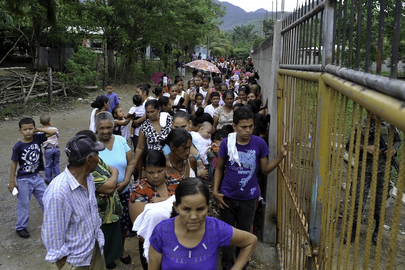 Locals wait outside the compound where the Joint Task Force-Bravo Medical Element hosted a Medical Readiness Training Exercise operation in Trujillo, Honduras, July 29, 2016. The villages where the MEDRETEs take place provide space at the schools, churches or community centers to see patients, and community leaders help with event promotion. (U.S. Air Force photo by Staff Sgt. Siuta B. Ika)