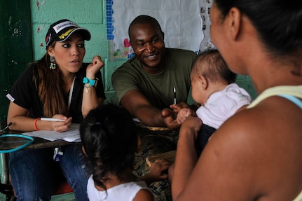 U.S. Navy Petty Officer 3rd Class Mercedes Macintosh, Special Purpose Marine Air-Ground Task Force hospital corpsman, smiles at a baby during a Medical Readiness Training Exercise operation consultation in Trujillo, Honduras, July 29, 2016. While MEDRETEs greatly help the local populations where they are conducted, the service members executing the operations also receive valuable medical training and experience that comes from operating in remote and/or austere environments. (U.S. Air Force photo by Staff Sgt. Siuta B. Ika)