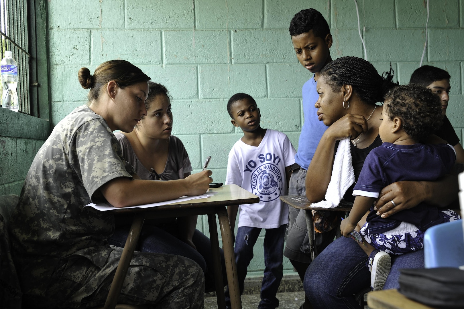 U.S. Army Spc. Lindsay Thompson, Joint Task Force-Bravo Medical Element medic, fills out paperwork during a Medical Readiness Training Exercise operation consultation in Trujillo, Honduras, July 29, 2016. U.S. military personnel from JTF-Bravo have been conducting MEDRETEs since 1993 and have treated more than 326,000 medical patients. (U.S. Air Force photo by Staff Sgt. Siuta B. Ika)