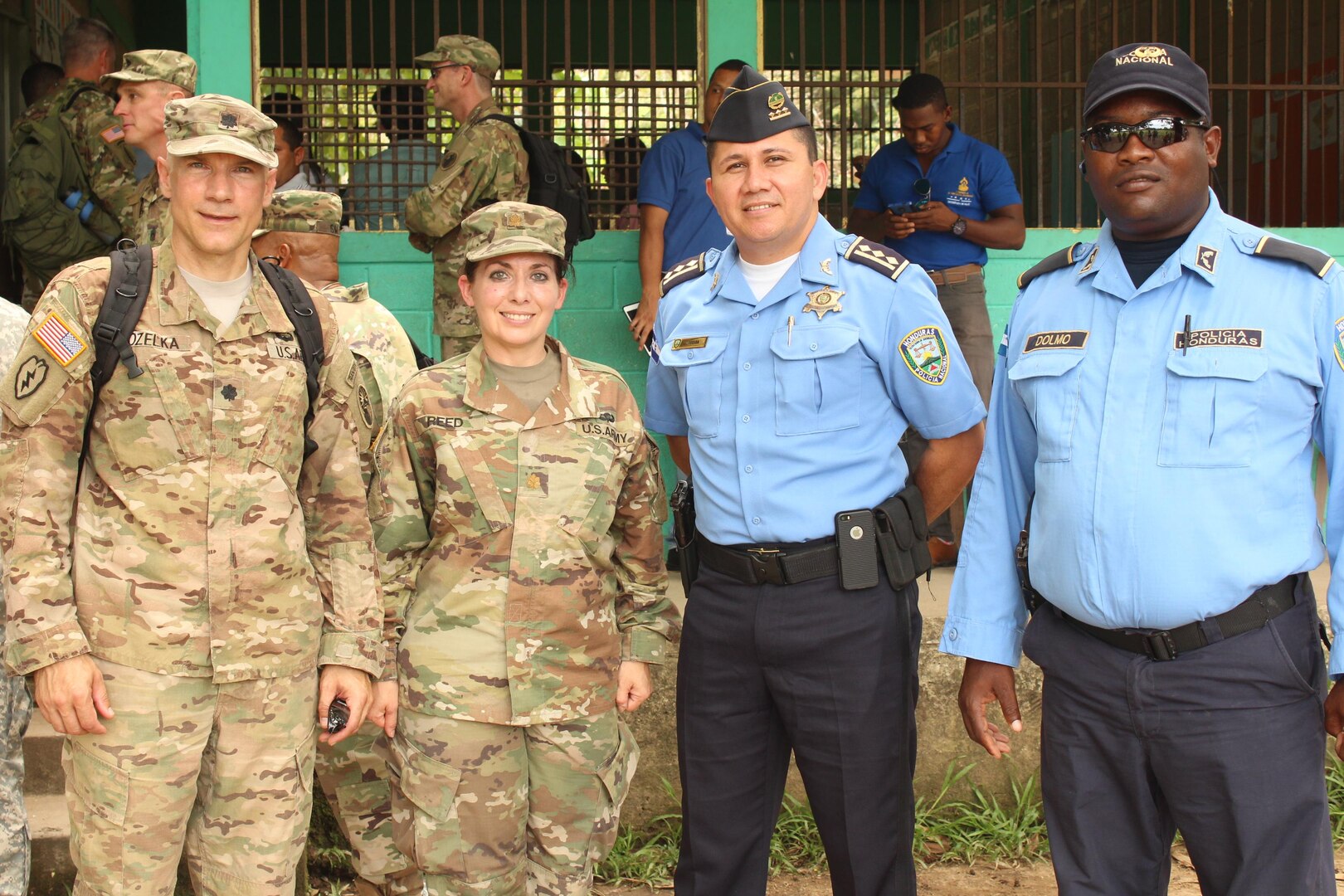 U.S. Army Lt. Col. Glenn Kozelka (far left), operations director for Joint Task Force-Bravo, and U.S. Army Major Rosemary Reed (left), Civil Military Operations deputy director for JTF-Bravo, pose for a photo with two Honduran Police Officers during a Medical Readiness Training Exercise in the village of La Boveda, Trujillo, July 29, 2016. A total of 1,072 patients of all ages received treatment during the two-day event that involved key leaders from both JTF-Bravo and Honduras. (U.S. Army photo by Maria Pinel)