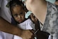 A young girl has her ear inspected by U.S. Army Spc. Kerry Holmes, Joint Task Force-Bravo Medical Element medic, during a Medical Readiness Training Exercise operation in Trujillo, Honduras, July 29, 2016. MEDEL conducts MEDRETEs throughout Central America to provide a variety of medical services to the local populations, who otherwise would be unable to receive medical care from licensed providers. (U.S. Air Force photo by Staff Sgt. Siuta B. Ika)