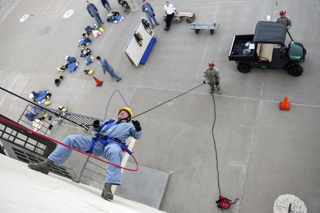 Air Force Lt. Col. Garrett Stumb rappels down a 3-story building during a fire marshal course at the Louis F. Garland Department of Defense Fire Academy at Goodfellow Air Force Base, Texas, Aug. 3, 2016. The base offered the course to enable civil engineer squadron commanders and similar representatives gain their fire marshal certification. Stumb commands the 315th Civil Engineer Squadron. Air Force photo by Airman 1st Class Caelynn Ferguson