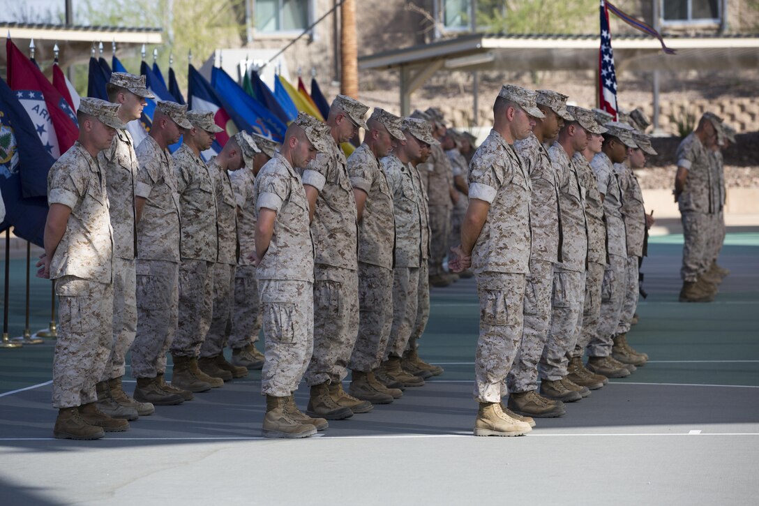 Marines with the Marine Corps Tactics and Operations Group bow their heads during the invocation as part of the unit’s change of command ceremony at the Dunham Amphitheater aboard Marine Corps Air Ground Combat Center, Twentynine Palms, Calif., July 29, 2016. During the ceremony, Col. Craig Wonson, outgoing commanding officer, relinquished command to Col. Tim Barrick, oncoming commanding officer. (Official Marine Corps photo by Cpl. Thomas Mudd/Released)