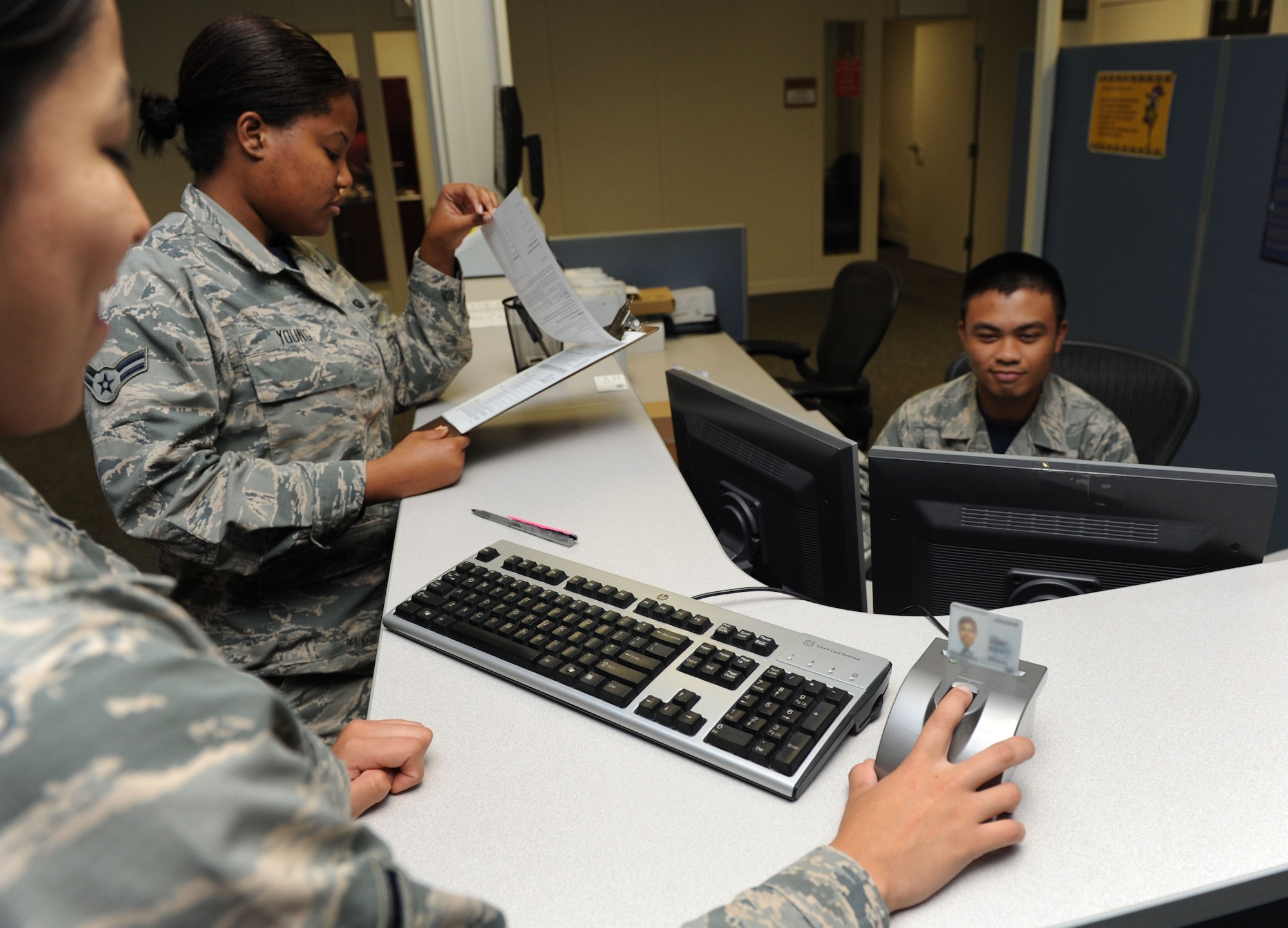 Airman Brenda Prudencio, 81st Force Support Squadron customer support technician, resets her common access card pin number with the assistance of Airmen 1st Class Cacinni Young and Jmb Baldonado, 81st FSS customer support technicians, at the Sablich Center Aug. 5, 2016, on Keesler Air Force Base, Miss. CAC pin reset machines have been placed at three locations: The Sablich Center, Room 125; the Keesler Medical Center, Room 4F102 and the Levitow Training Support Facility, Room 228. (U.S. Air Force photo by Kemberly Groue)