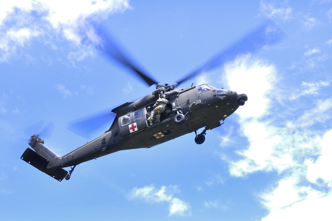 Army Staff Sgt. Stephen Trala is lowered from a HH-60 Black Hawk helicopter and prepares to pick up a simulated casualty during a search-and-rescue exercise as part of Vigilant Guard 2016 at Camp Ethan Allen Training Site, Jericho, Vt., 2016. Trala is a flight medic assigned to Company C, 3rd Battalion, 126th Aviation Regiment Air Ambulance. Army National Guard photo by Staff Sgt. Ashley Hayes 
