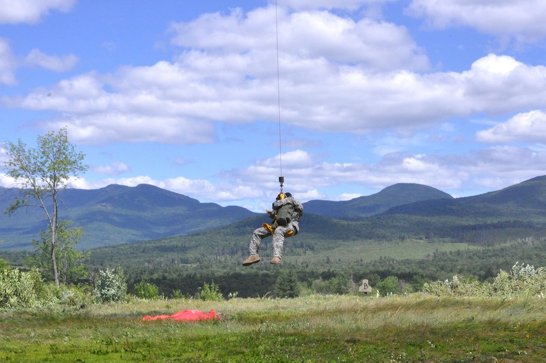 Army Staff Sgt. Stephen Trala is lowered from a HH-60 Black Hawk helicopter and prepares to pick up a simulated casualty during a search-and-rescue exercise as part of Vigilant Guard 2016 at Camp Ethan Allen Training Site, Jericho, Vt., 2016. Trala is a flight medic assigned to Company C, 3rd Battalion, 126th Aviation Regiment Air Ambulance. Army National Guard photo by Staff Sgt. Ashley Hayes