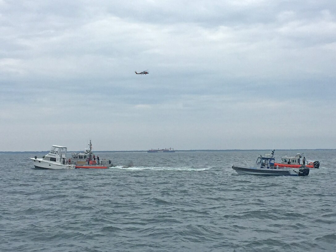 U.S. Coast Guard assets, including an MH-60 Jayhawk helicopter, and other emergency vessels assist a vessel in distress on the Chesapeake Bay after receiving the exact location of the distressed vessel from U.S. Army Corps of Engineers, Baltimore District's Survey Vessel LINTHICUM Sunday Aug. 7, 2016. LINTHICUM responded after being notified by a passing ship of a nearby flare while conducting a condition survey of the nearby Cape Henry Channel.