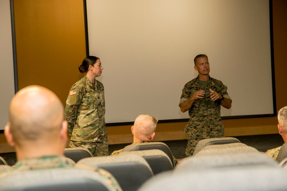 MARINE CORPS BASE CAMP LEJEUNE, N.C. – Major Gen. Carl E. Mundy III, commanding general of U.S. Marine Corps Forces, Special Operations Command, speaks about U.S. Army Capt. Emily R. Bingham during an award ceremony aboard Marine Corps Base Camp Lejeune, N.C., July 29, 2016. Bingham received the 2016 U.S. Army Veterinary Corps Veterinary Services Officer Exceptional Service Award for serving as the MARSOC force veterinarian. This is the third MARSOC veterinarian in a row to receive this award. (U.S. Marine Corps photo by Cpl. Ryan C. Mains/ Released)