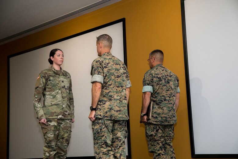 MARINE CORPS BASE CAMP LEJEUNE, N.C. – U.S. Army Captain Emily R. Bingham stands at attention during an award ceremony aboard Marine Corps Base Camp Lejeune, N.C., July 29, 2016. Bingham received the 2016 U.S. Army Veterinary Corps Veterinary Services Officer Exceptional Service Award for serving as the MARSOC force veterinarian. This is the third MARSOC veterinarian in a row to receive this award. (U.S. Marine Corps photo by Cpl. Ryan C. Mains/ Released)