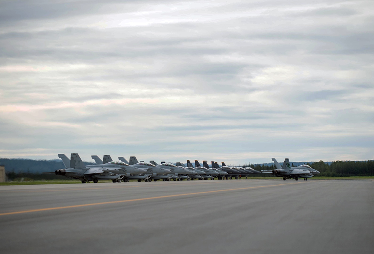 U.S. Air Force F-15E Strike Eagle dual-role fighter aircraft assigned to the 336th Fighter Squadron, Seymour Johnson Air Force Base, N.C., U.S. Navy EA-18G Growler aircraft assigned to the Electronic Attack Squadron 135, Naval Air Station Whidbey Island, Wash., and Royal Canadian Air Force CF-18 Hornet fighter aircraft assigned to the 409th Tactical Fighter Squadron, Canadian Forces Base Cold Lake, Canada, line up at the end of runway Aug. 5, 2016, at Eielson Air Force Base, Alaska, during familiarization day of RED FLAG-Alaska (RF-A) 16-3. Free exchange of ideas between multilateral forces during RF-A enhances not just partners and sister service relationships, but also their operational efficiency. 