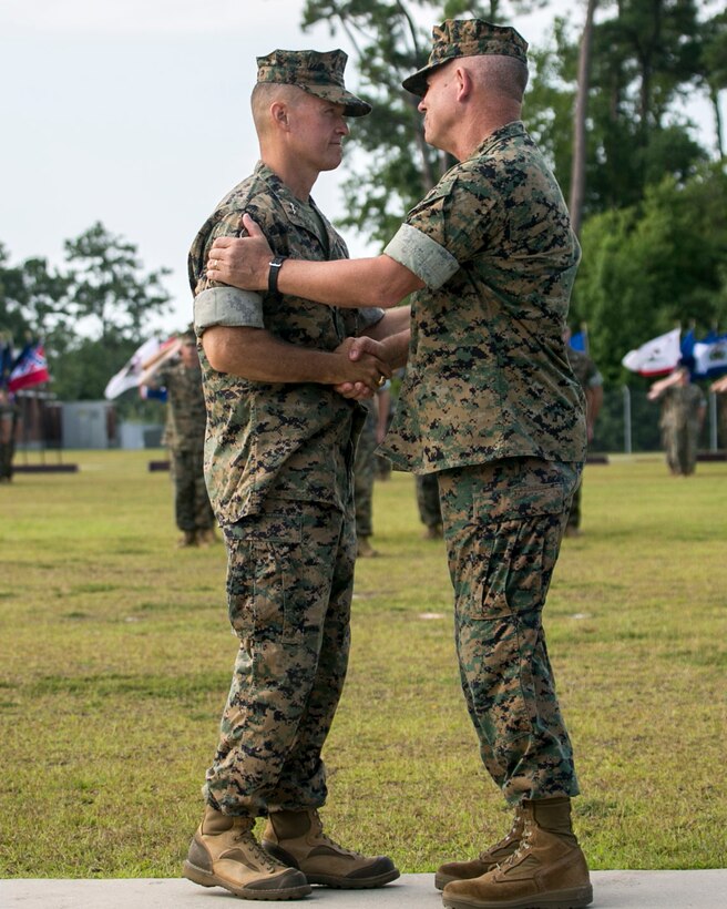 MARINE CORPS BASE CAMP LEJEUNE, N.C. – Major Gen. Carl E. Mundy III, left, shakes hands with Maj. Gen. Joseph L. Osterman, during a change of command ceremony aboard Marine Corps Base Camp Lejeune, N.C., July 26, 2016. During the ceremony, Osterman relinquished his responsibilities as commanding general of U.S. Marine Corps Forces, Special Operations Command to Mundy. (U.S. Marine Corps photo by Cpl. Ryan C. Mains/ Released)