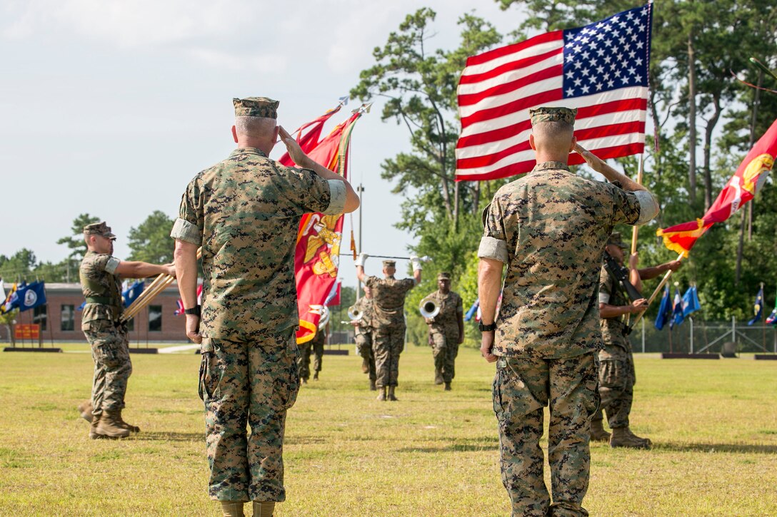 MARINE CORPS BASE CAMP LEJEUNE, N.C. – Major Gen. Joseph L. Osterman, left, and Maj. Gen. Carl E. Mundy III salute the national ensign during a change of command ceremony aboard Marine Corps Base Camp Lejeune, N.C., July 26, 2016. During the ceremony, Osterman relinquished his responsibilities as commanding general of U.S. Marine Corps Forces, Special Operations Command to Mundy. (U.S. Marine Corps photo by Cpl. Ryan C. Mains/ Released)