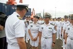 Cmdr. Justin Harts, commanding officer of the guided-missile destroyer USS Benfold (DDG 65), greets members of the People's Liberation Army (Navy), Aug. 8, 2016, after the ship's arrival for a port visit. Benfold's visit advances maritime cooperation and encourages a positive naval relationship with the People's Liberation Army (Navy), North Sea Fleet.
