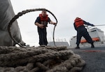 Gunner's Mate 2nd Class James Callison coils line aboard the guided-missile destroyer USS Momsen (DDG 92) during a replenishment-at-sea with the fleet replenishment oiler USNS Joshua Humphreys (T-AO 188), Aug. 8, 2016. The guided-missile destroyers USS Spruance (DDG 111), USS Decatur (DDG 73- and Momsen are deployed in support of maritime security and stability in the Indo-Asia Pacific as part of a U.S. 3rd Fleet Pacific Surface Action Group (PAC SAG) under Commander, Destroyer Squadron (CDS) 31.