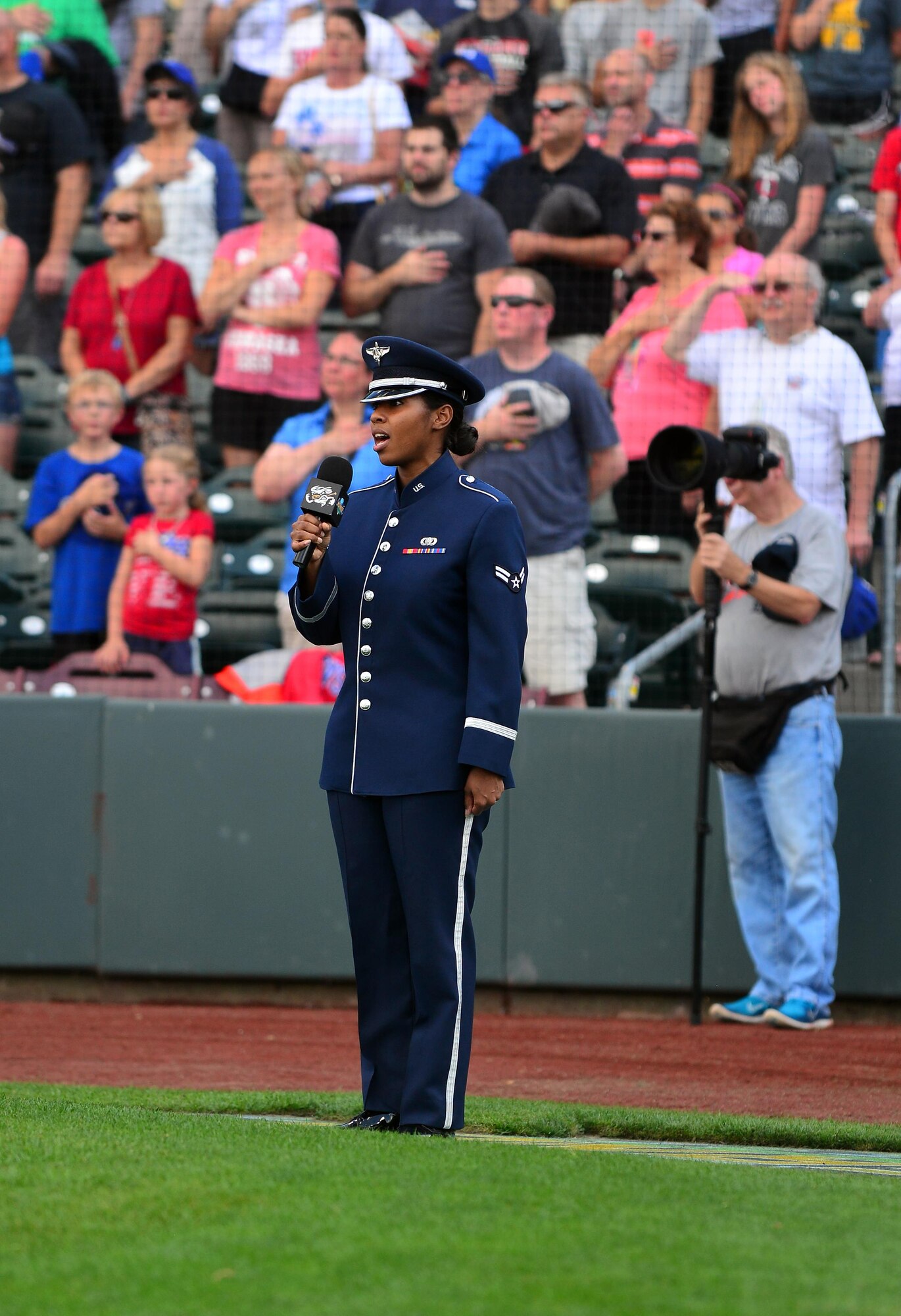 U.S. Air Force Airman 1st Class Sierra Bailey, a vocalist with the U.S. Air Force Heartland of America Band, sings the National Anthem during the Omaha Storm Chaser’s military appreciation night at Werner Park in Papillion, Nebraska Aug. 7.  The Storm Chasers are the Triple-A affiliate of the Kansas City Royals.  (U.S. Air Force photo by Josh Plueger)