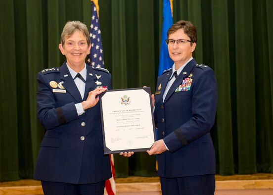 General Ellen Pawlikowski, AFMC commander, hands Maj. Gen. Theresa Carter her certificate of retirement during her retirement ceremony July 22 at Joint Base San Antonio-Lackland, Texas. (U.S. Air Force photo by SSgt Marissa Garner)