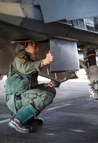 U.S. Marine Corps Maj. Alexander Goodno, Marine exchange pilot with the Royal Australian Air Force No. 75 Squadron, conducts a preflight check on an F/A-18 Hornet during Exercise Pitch Black at RAAF Base Tindal, Australia, Aug. 5, 2016. Goodno has been stationed with No. 75 Squadron for two and a half years with the Marine Corps Foreign Personnel Exchange Program. This program enhances worldwide security cooperation by continuing long-term presence and association among military counterparts. Goodno serves as a liaison officer to the participating U.S. units, explaining foreign jargon and procedures. (U.S. Marine Corps photo by Cpl. Nicole Zurbrugg)