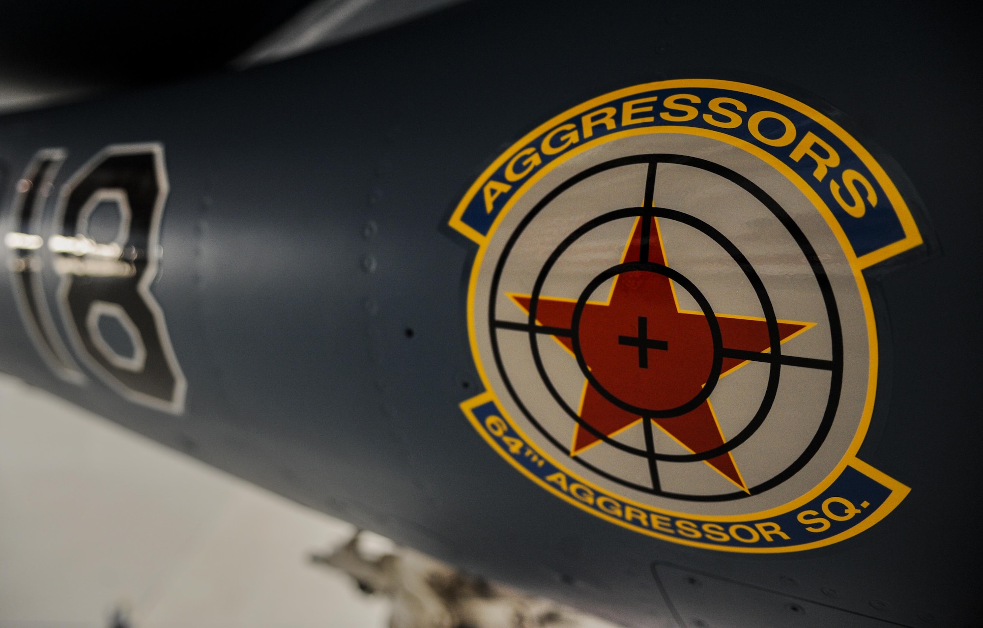 The 64th Aggressor Squadron, Nellis Air Force Base, Nev., debut the new paint scheme for the F-16 Aggressors during the 57th Adversary Tactics Group change of command ceremony Aug. 5, 2016. Since 1972, the 64th Aggressor Squadron has prepared combat air forces by providing realistic threat replication and training. (U.S. Air Force photo by Airman 1st Class Kevin Tanenbaum/Released)