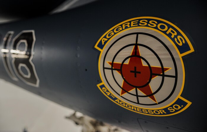 The 64th Aggressor Squadron, Nellis Air Force Base, Nev., debut the new paint scheme for the F-16 Aggressors during the 57th Adversary Tactics Group change of command ceremony Aug. 5, 2016. Since 1972, the 64th Aggressor Squadron has prepared combat air forces by providing realistic threat replication and training. (U.S. Air Force photo by Airman 1st Class Kevin Tanenbaum/Released)